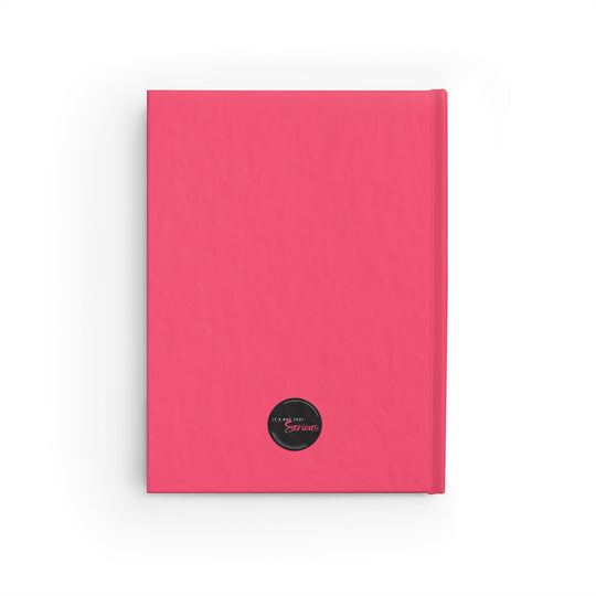 Pink notebook with a black circular label on a white background