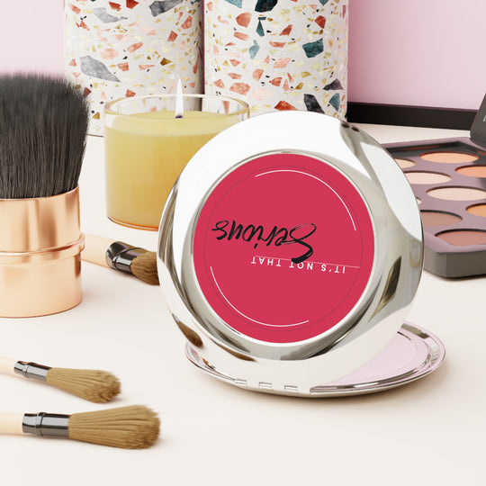 Makeup compact with pink lid featuring 'Sculpt' brand, surrounded by brushes and a candle on a light background.