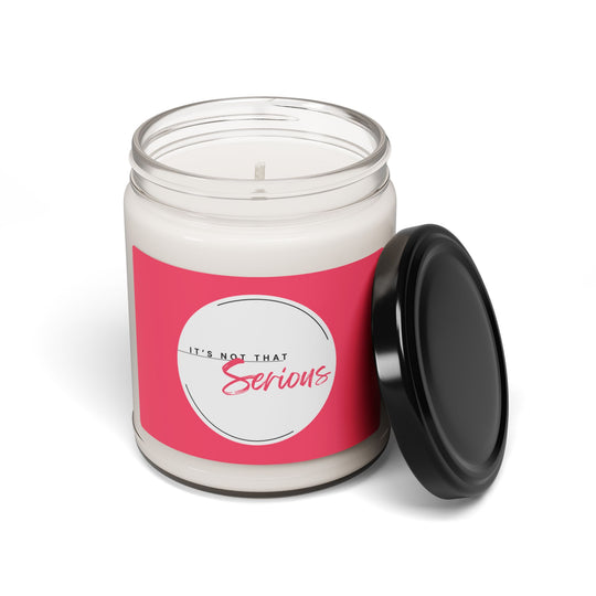 Candle jar with pink label and black lid on a white background