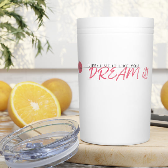 White tumbler with motivational quote on a table with lemons and a plant in the background