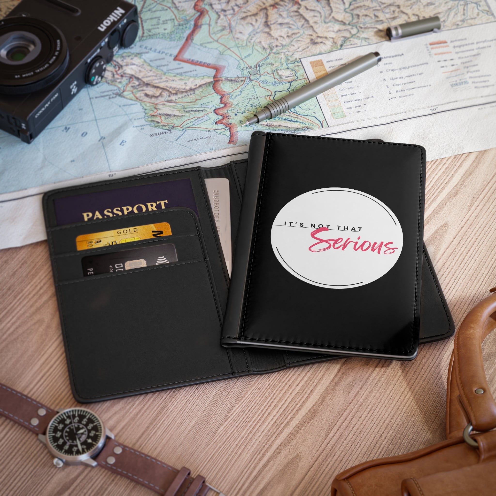 Black travel wallet with passport holder on a map background