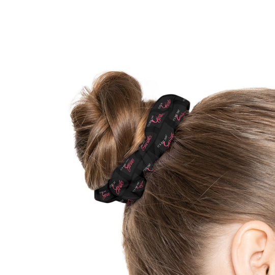 A black scrunchie with pink text all-over print, on a white background.
