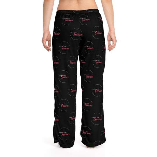 A pair of women's black pajama pants with a red and white text pattern and a drawstring waist.