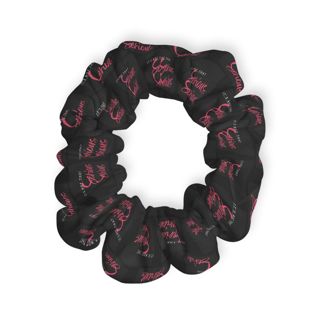A black scrunchie with pink text all-over print, on a white background.