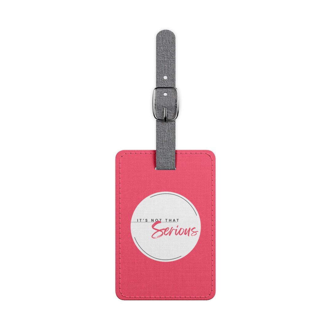 Pink luggage tag with a white label and text on a white background