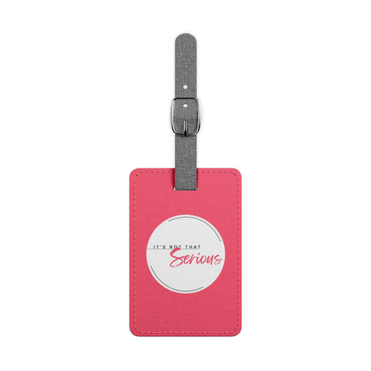 Pink luggage tag with a white label and text on a white background